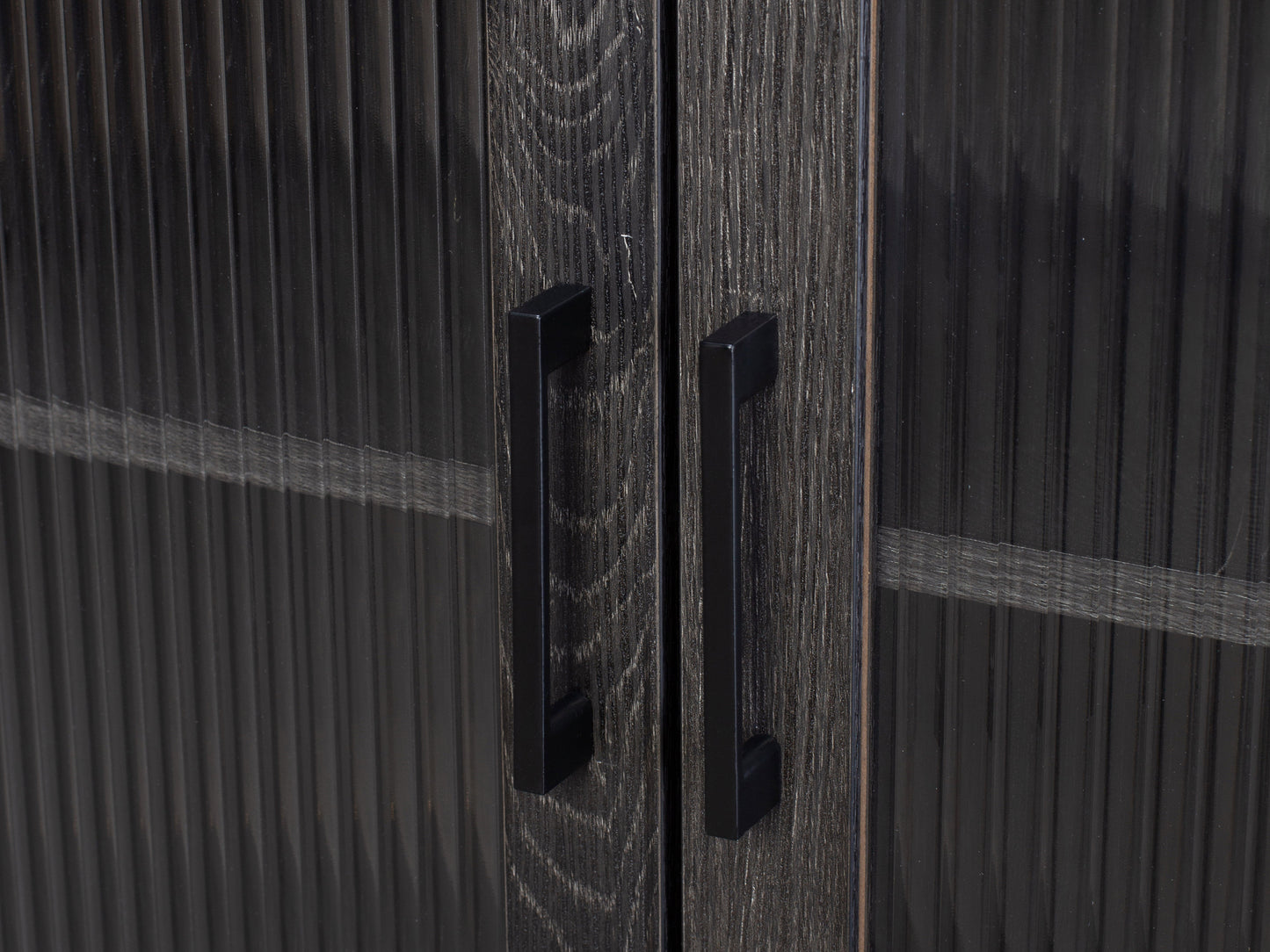 Fluted glass buffet cabinet with black metal frame, light wood finish, and textured glass doors featuring vertical ribbed patterns. Elegant dining storage solution with modern design and ample space for dishware.