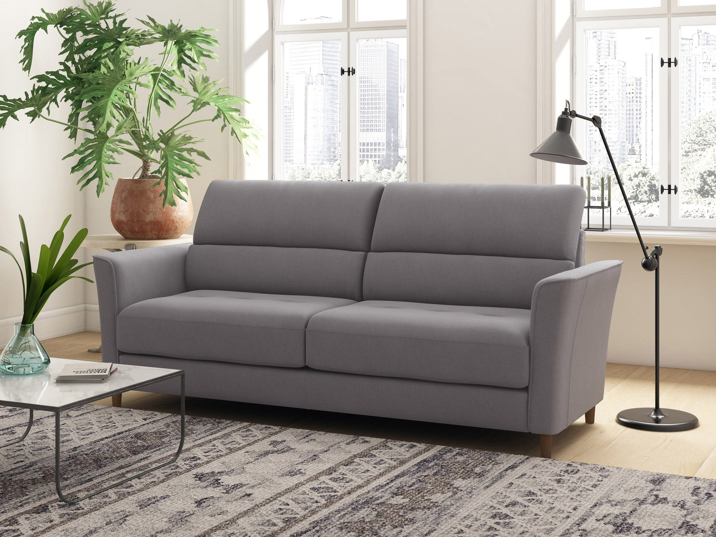 Light grey 3-seater sofa with plush cushions, wooden legs, and soft fabric upholstery. Ideal for modern living rooms, this stylish couch offers comfort and elegance, perfect for family gatherings or relaxation.