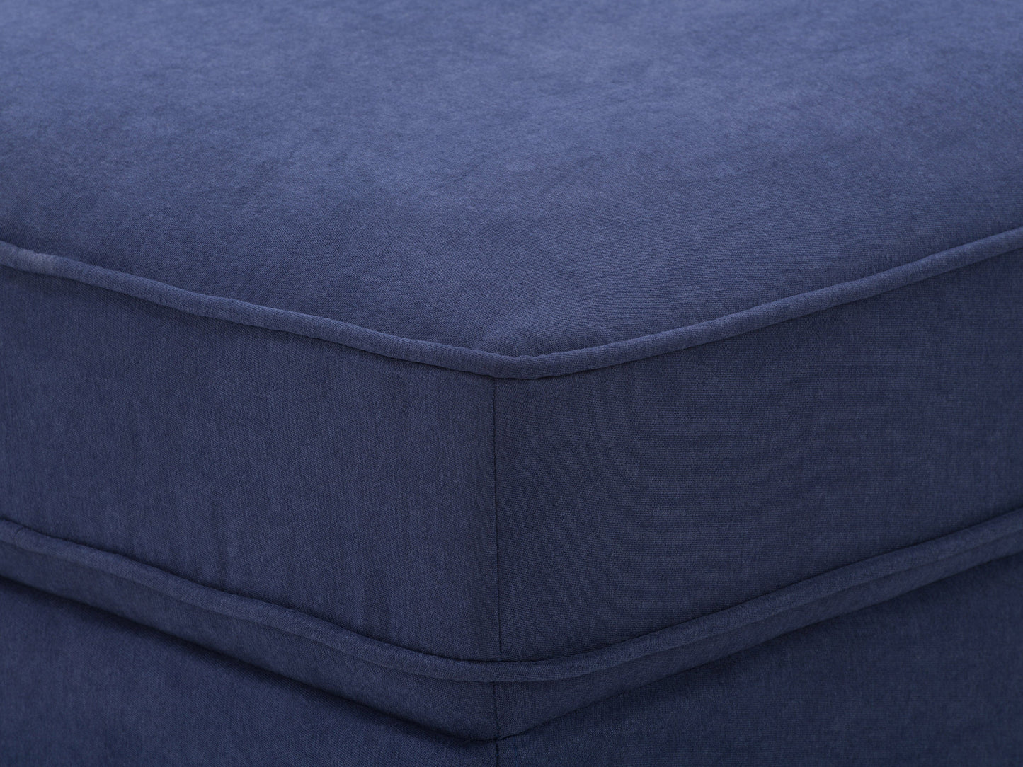 Navy blue mid-century modern ottoman with wooden legs, tufted fabric, and sleek design. Perfect for living room or bedroom decor.