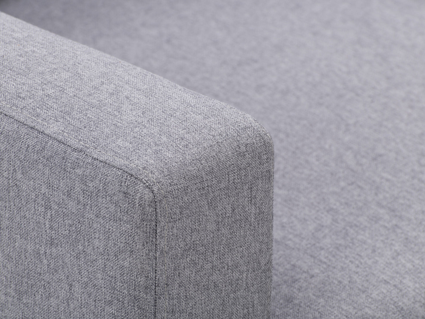 Grey tufted accent chair with wooden legs, featuring soft fabric upholstery, button-tufted backrest, and cushioned seat for comfort. Ideal for living rooms or reading nooks.