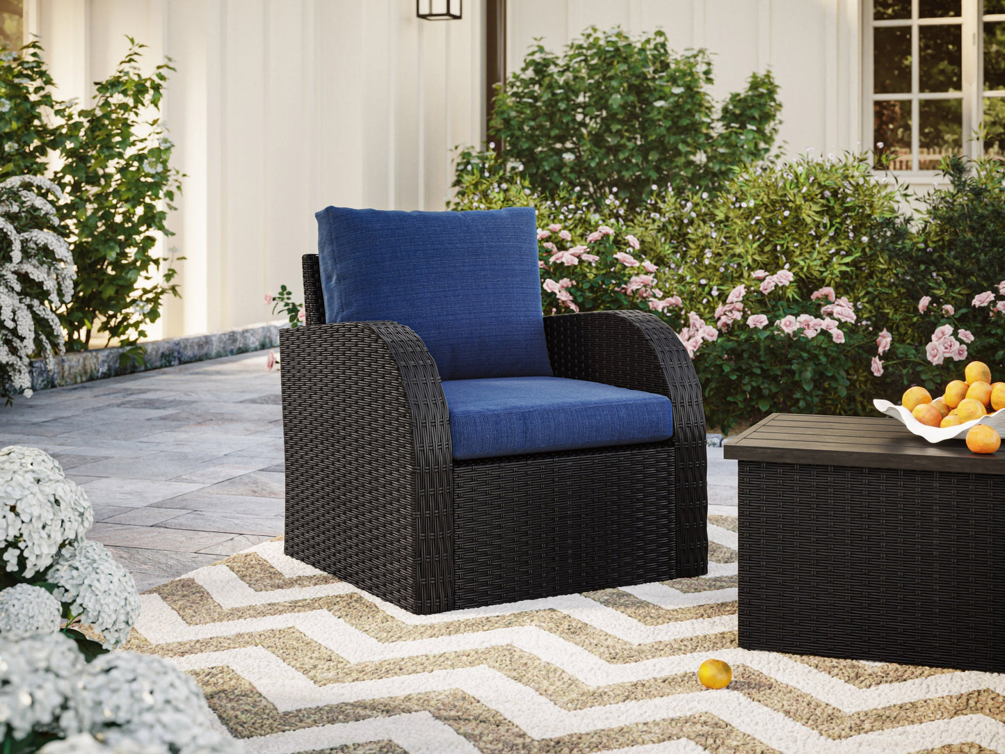 Blue outdoor wicker patio chair with cushioned seat and backrest, featuring durable woven rattan material and weather-resistant frame, perfect for garden or balcony seating.