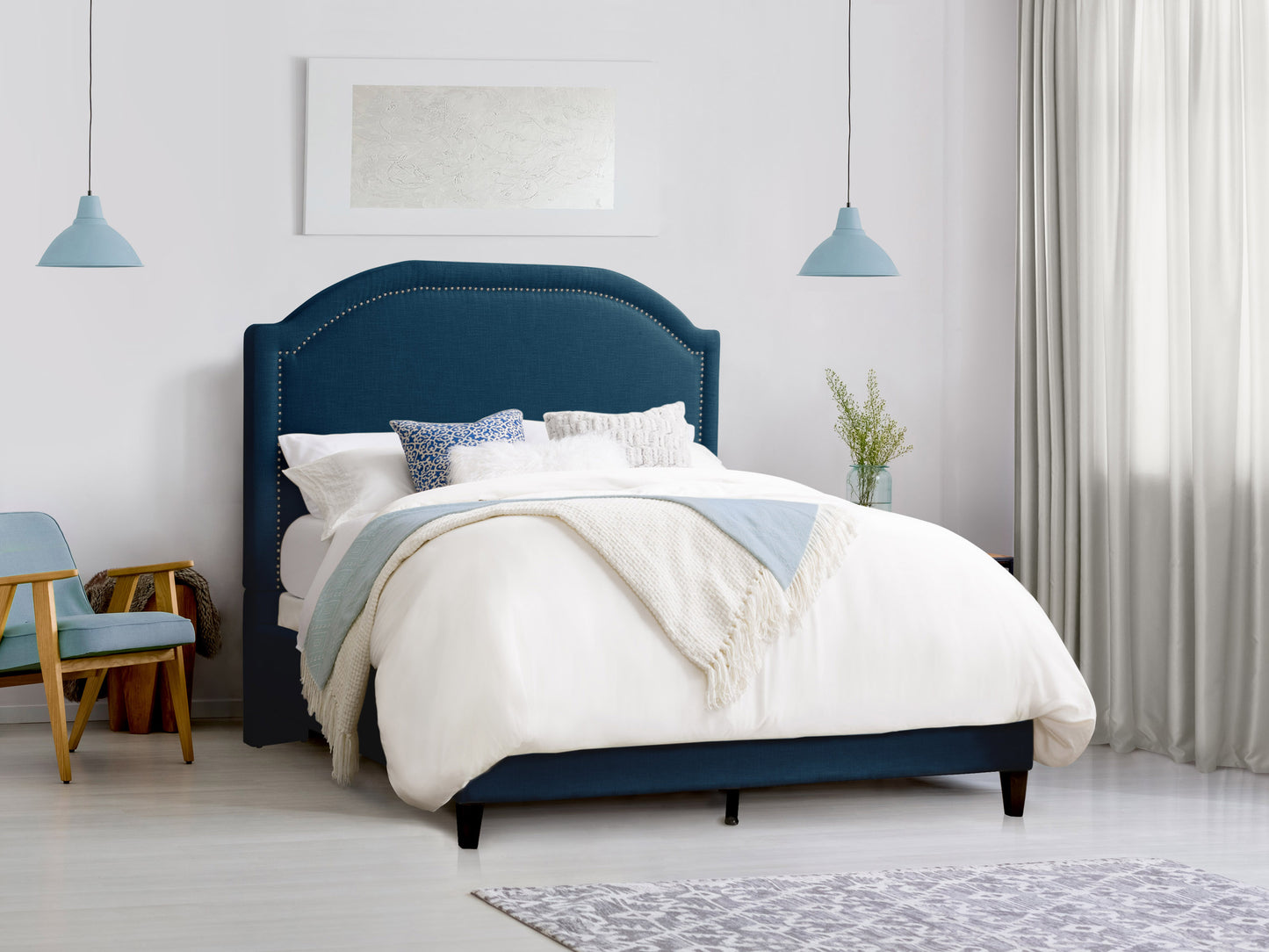 Gray upholstered double bed with tufted headboard, wooden legs, and elegant design. Perfect for modern bedrooms, offering comfort and style.