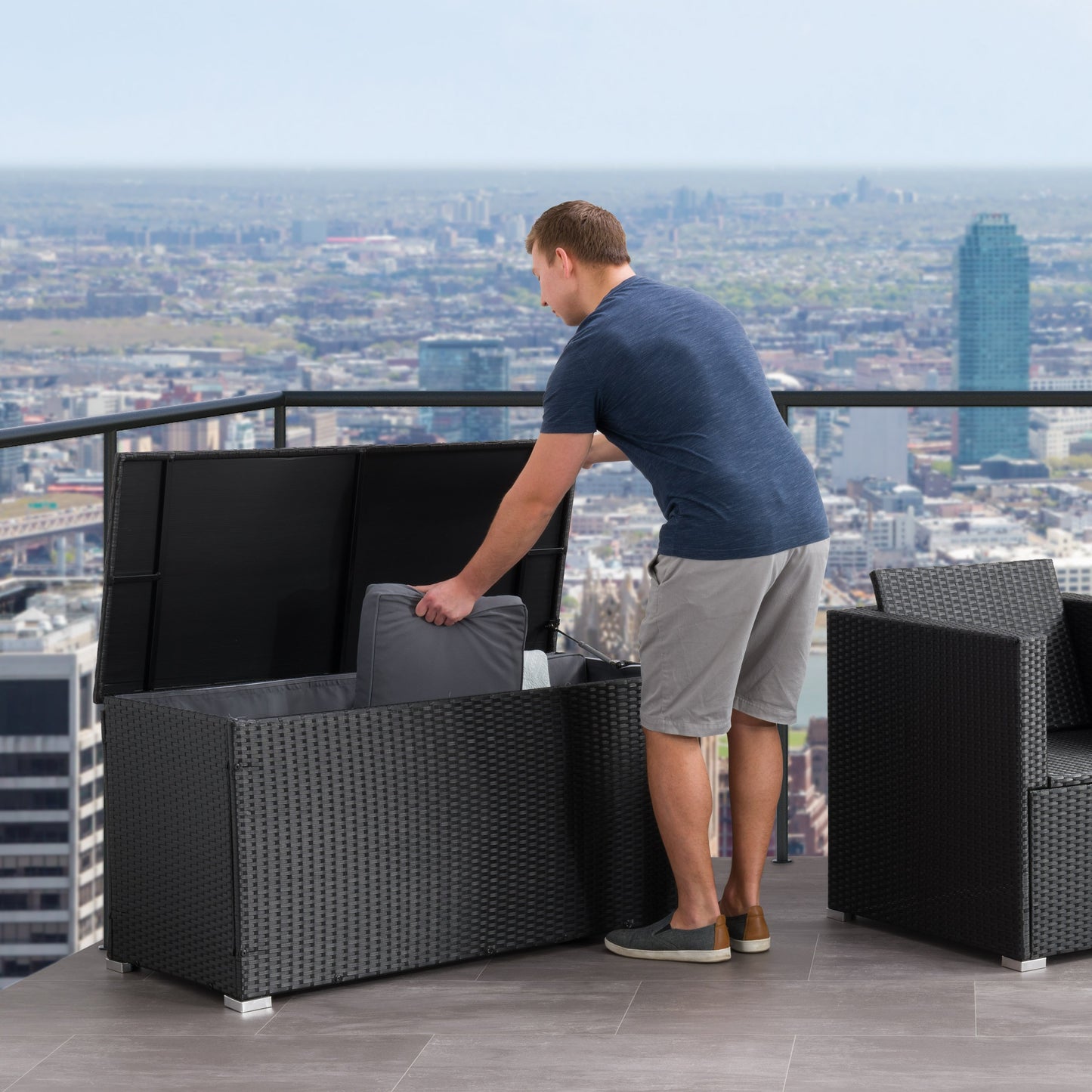 Grey wicker patio cushion box with a hinged lid, weather-resistant design, and spacious interior for outdoor storage. Perfect for keeping patio cushions, garden tools, and pool accessories organized and protected.