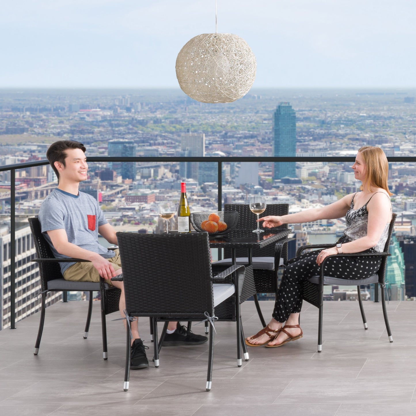 Modern 5-piece patio dining set with a rectangular glass table and four cushioned chairs in beige and brown wicker, featuring weather-resistant materials and a sleek design perfect for outdoor spaces.