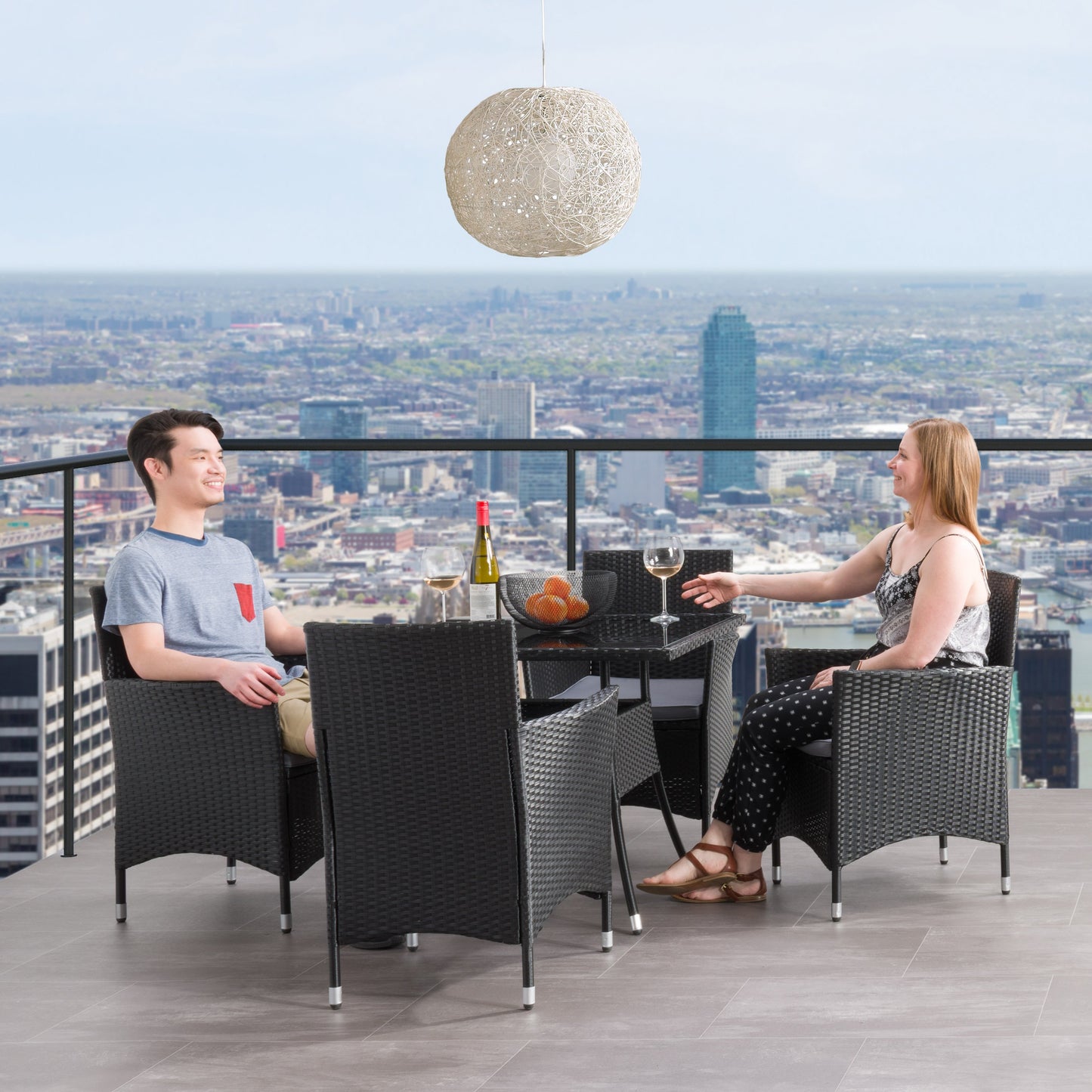 Modern 5-piece patio dining set with a rectangular glass table and four cushioned chairs in beige and brown wicker, featuring weather-resistant materials and a sleek design perfect for outdoor spaces.