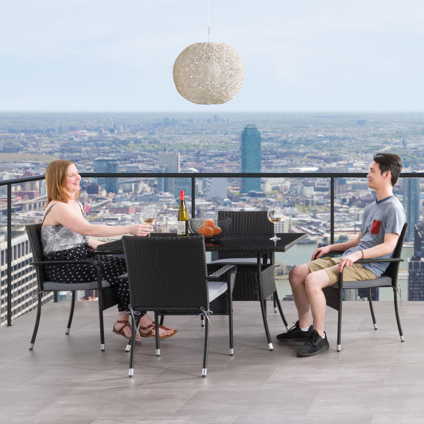 Modern 5-piece patio dining set with a rectangular glass table and four cushioned chairs in beige and brown wicker, featuring weather-resistant materials and a sleek design perfect for outdoor spaces.