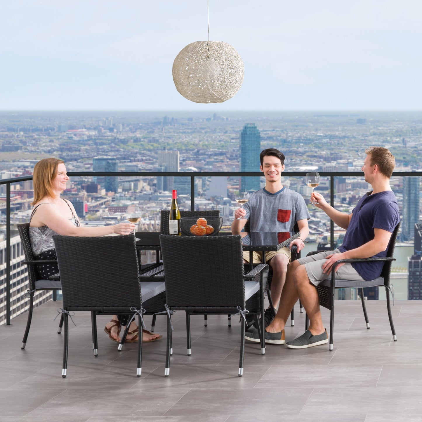 Gray wicker patio dining set with six cushioned chairs, rectangular glass-top table, and weather-resistant materials, perfect for outdoor dining and entertaining.