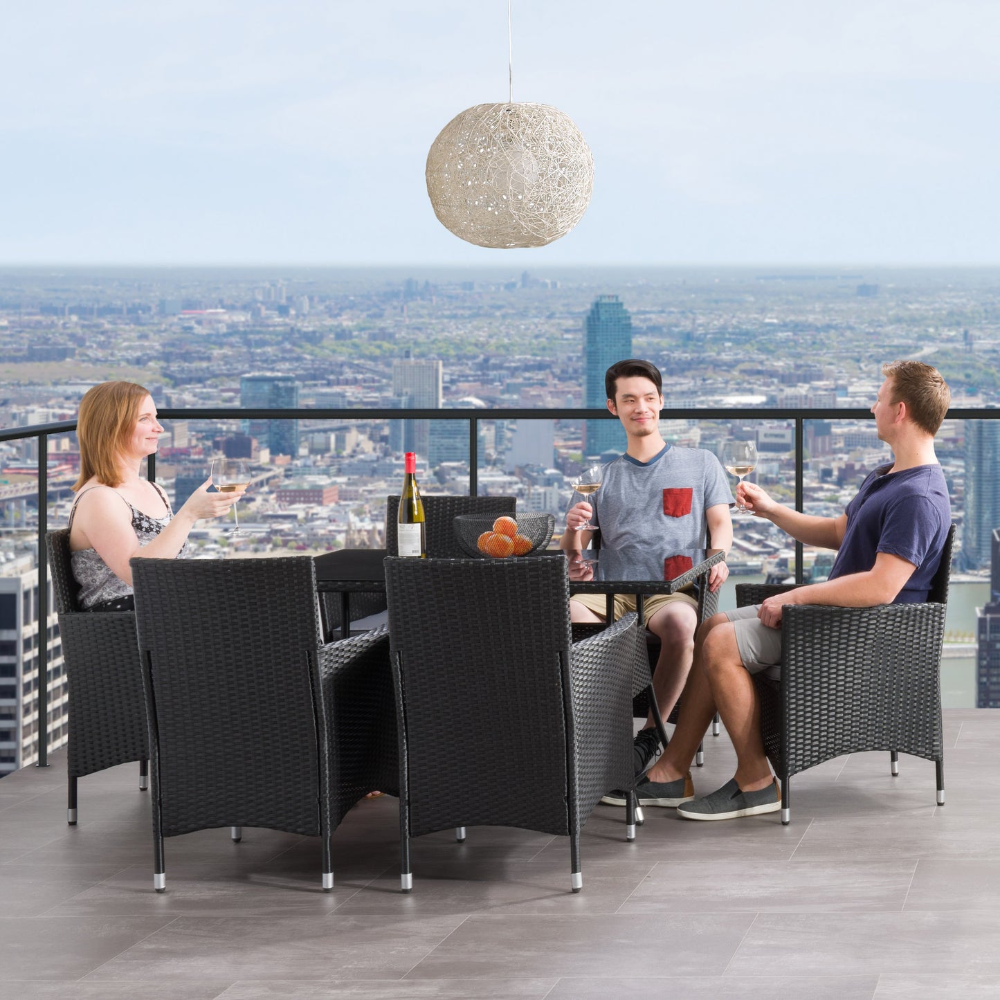 Gray wicker patio dining set with six cushioned chairs, rectangular glass-top table, and weather-resistant materials, perfect for outdoor dining and entertaining.