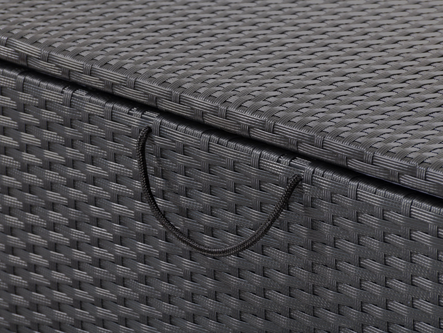 Gray wicker patio storage box with a flat lid, featuring a weather-resistant design and ample storage space, ideal for outdoor cushions and gardening tools.
