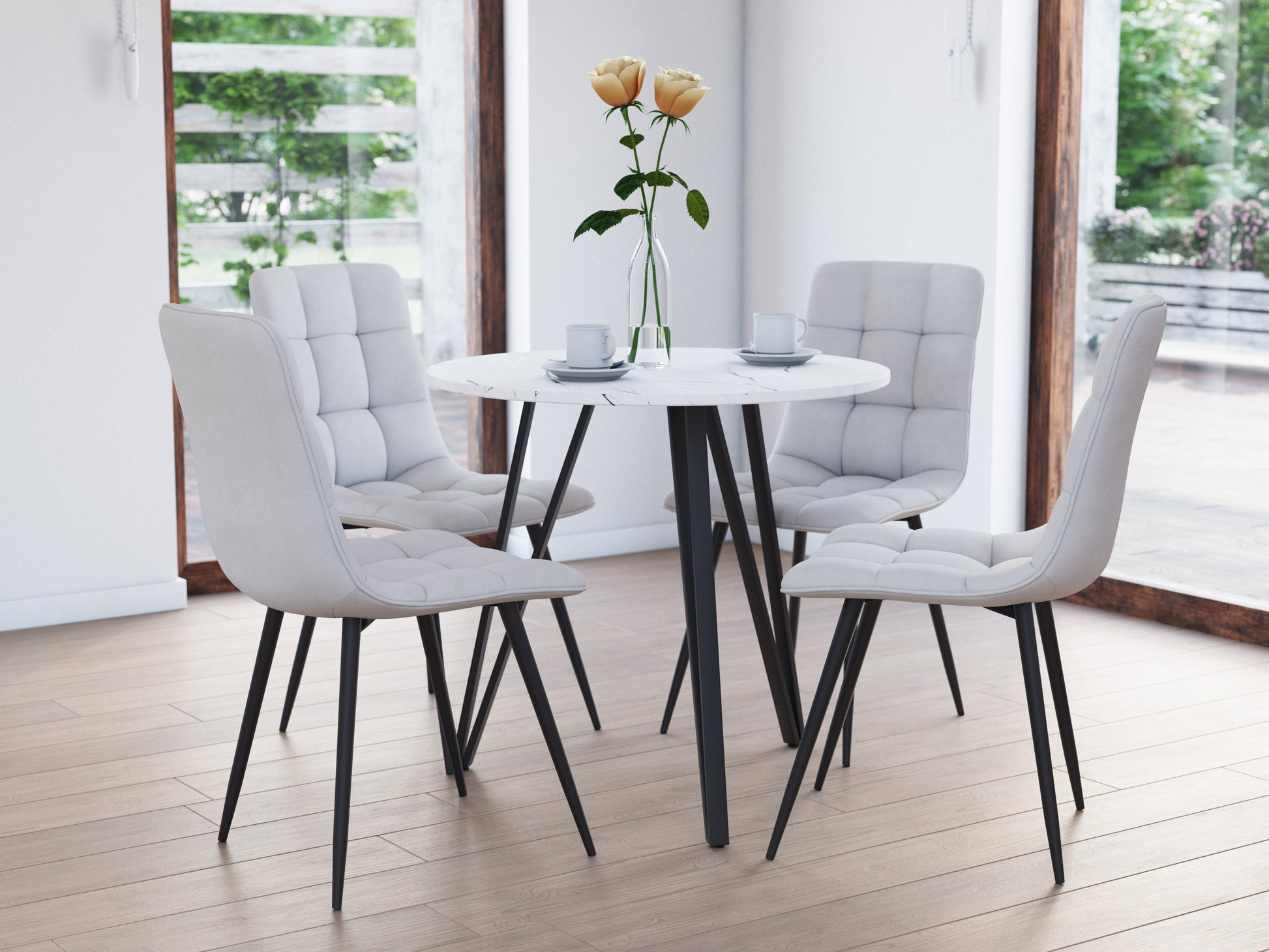 Small round dining table with a white marble top and sleek black metal legs, ideal for modern dining rooms.