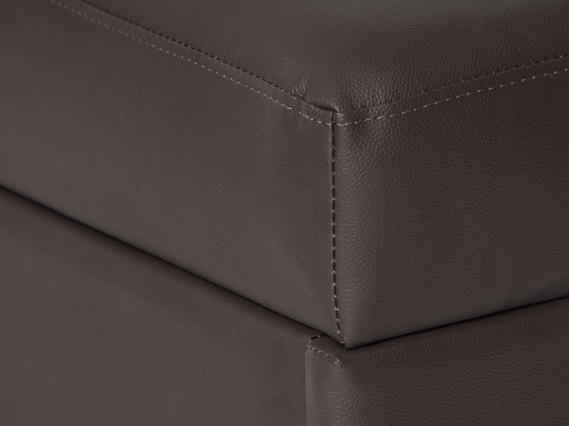 Brown vegan leather storage ottoman with tufted top, rectangular shape, and hidden storage compartment. Ideal for living rooms or bedrooms, offering both style and functionality.