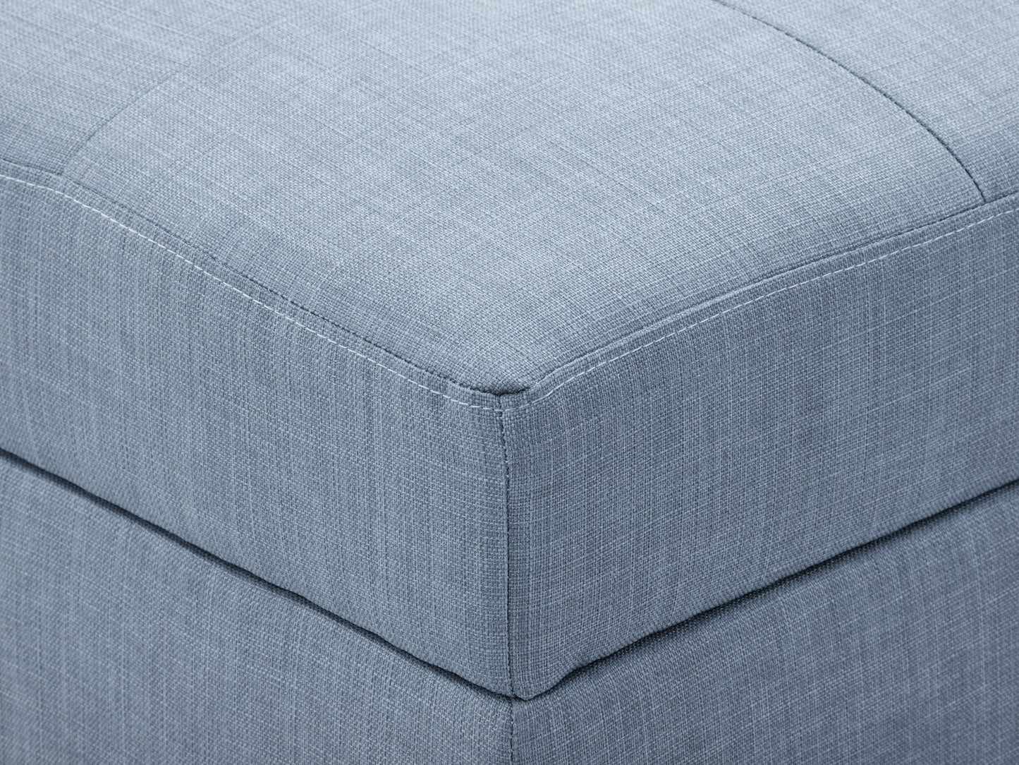 Tufted storage ottoman in light grey fabric with button detailing, wooden legs, and spacious interior storage. Ideal for living room or bedroom decor, combining style and functionality.