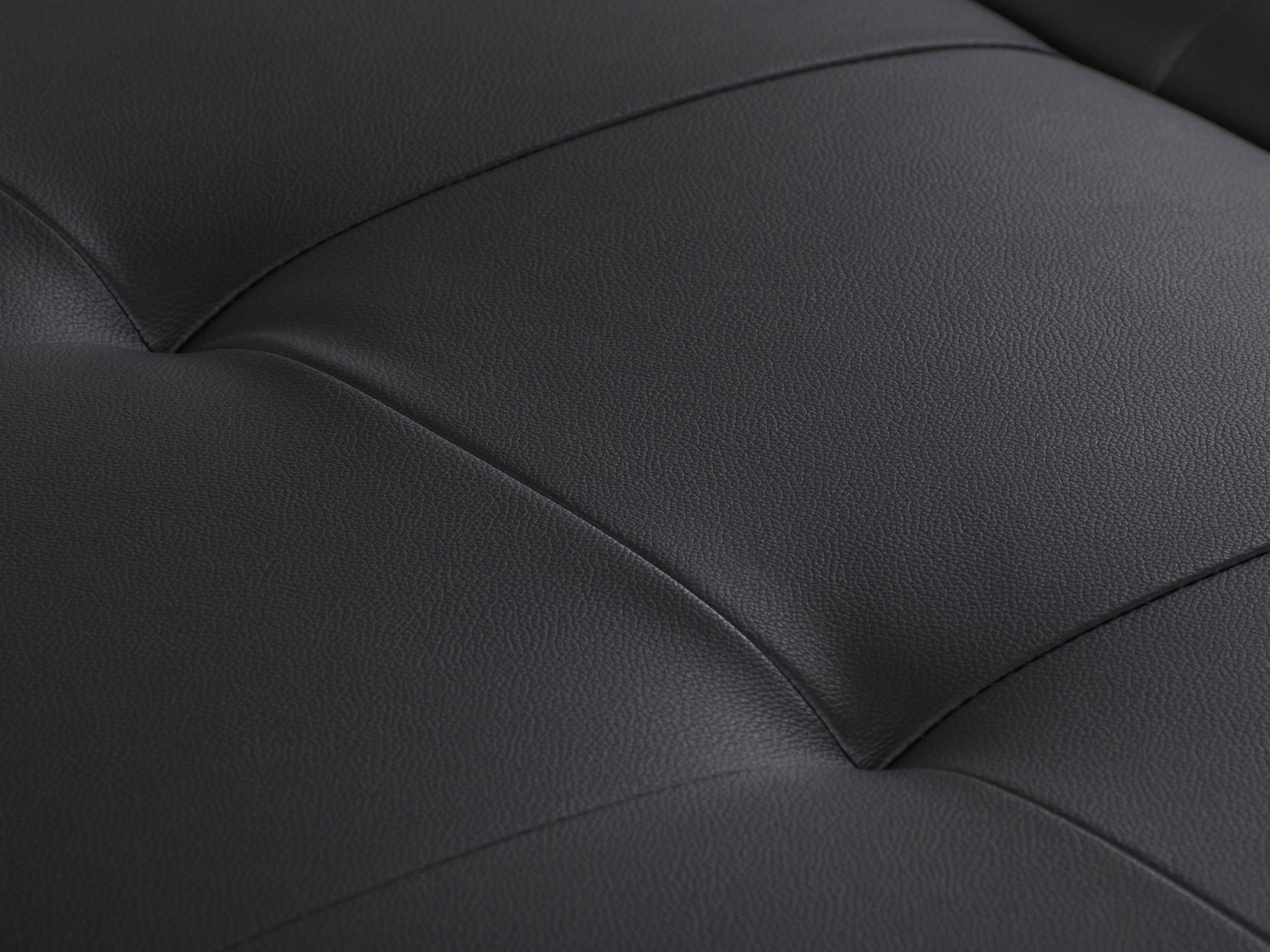 Matte black deluxe storage ottoman with tufted faux leather upholstery, spacious interior storage, and sleek minimalist design. Ideal for modern living rooms and versatile as extra seating or a coffee table.