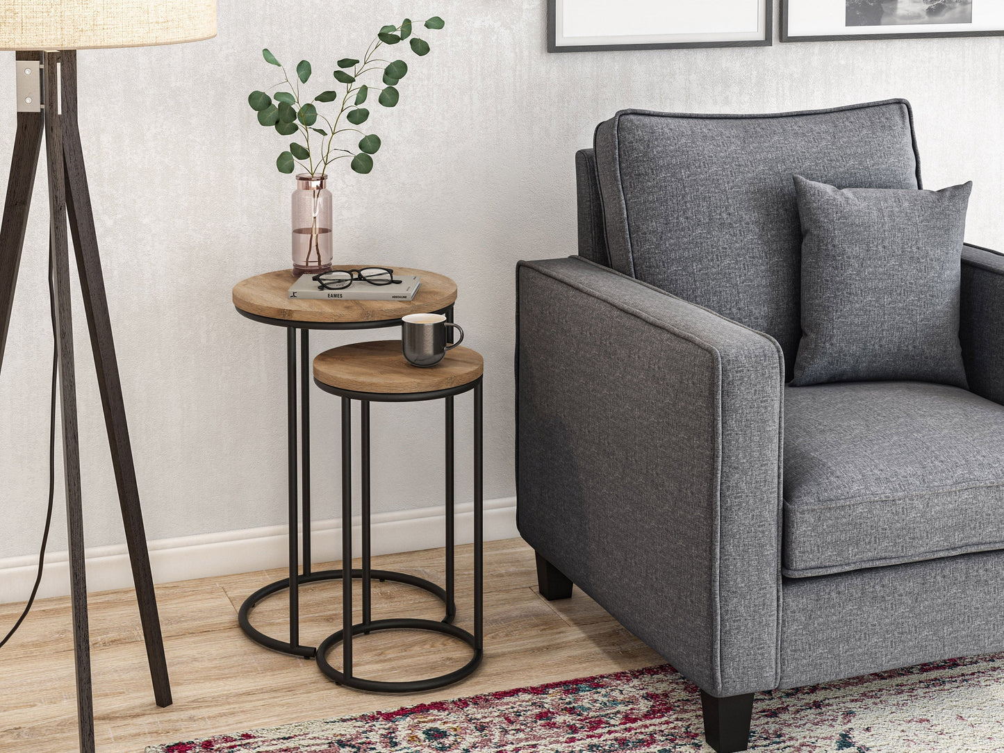Light wood round nesting side tables with sleek black metal legs, minimalist design, smooth finish, and stackable functionality for space-saving versatility. Ideal for modern living rooms and small spaces.