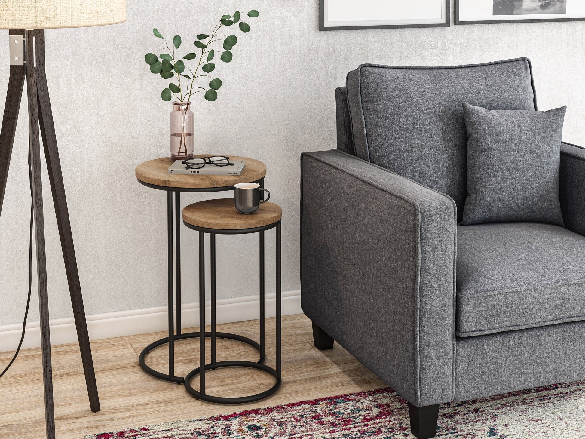 Light wood round nesting side tables with sleek black metal legs, minimalist design, smooth finish, and stackable functionality for space-saving versatility. Ideal for modern living rooms and small spaces.