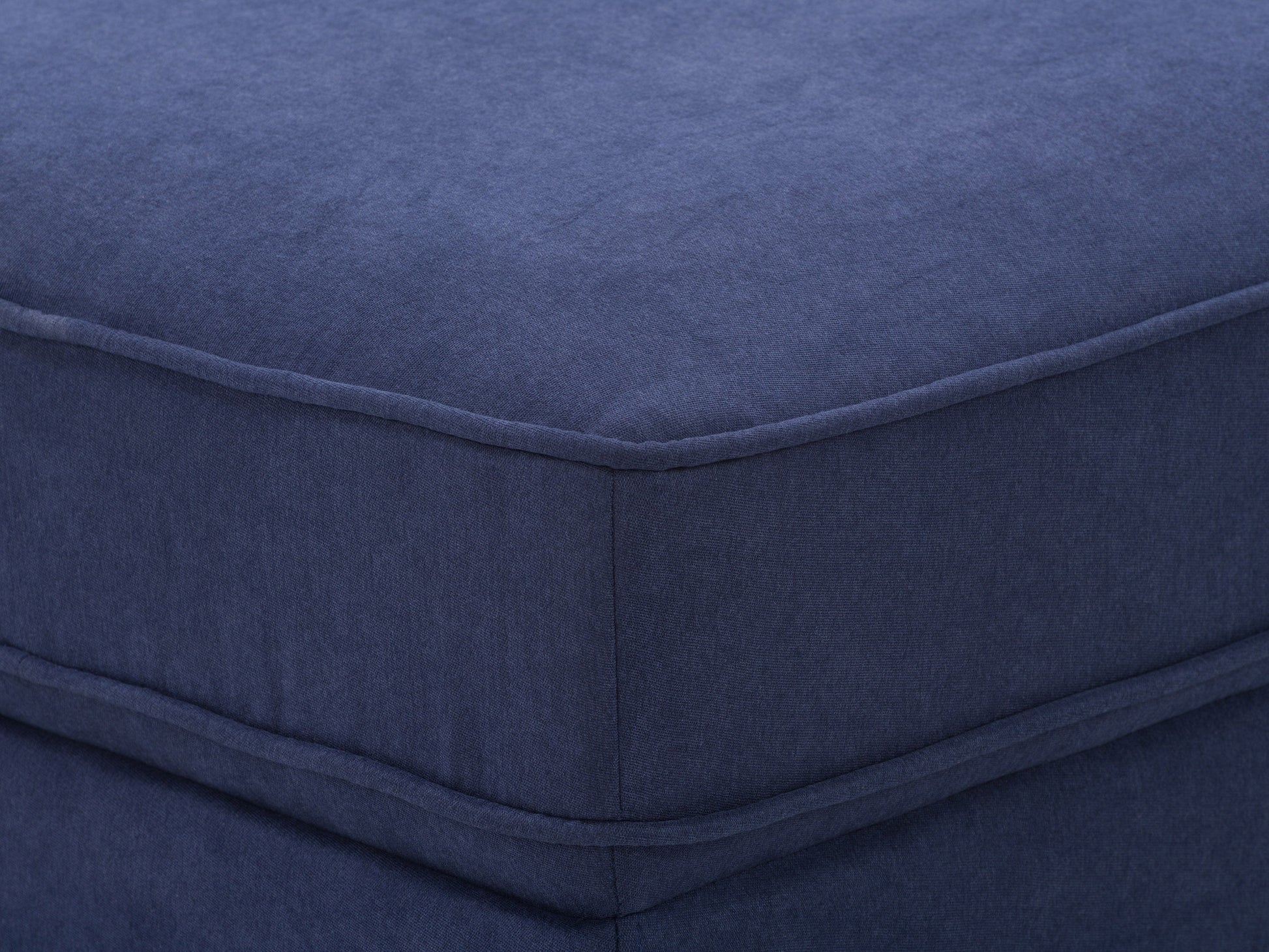 Navy blue mid-century modern ottoman with wooden legs, tufted fabric, and sleek design. Perfect for living room or bedroom decor.
