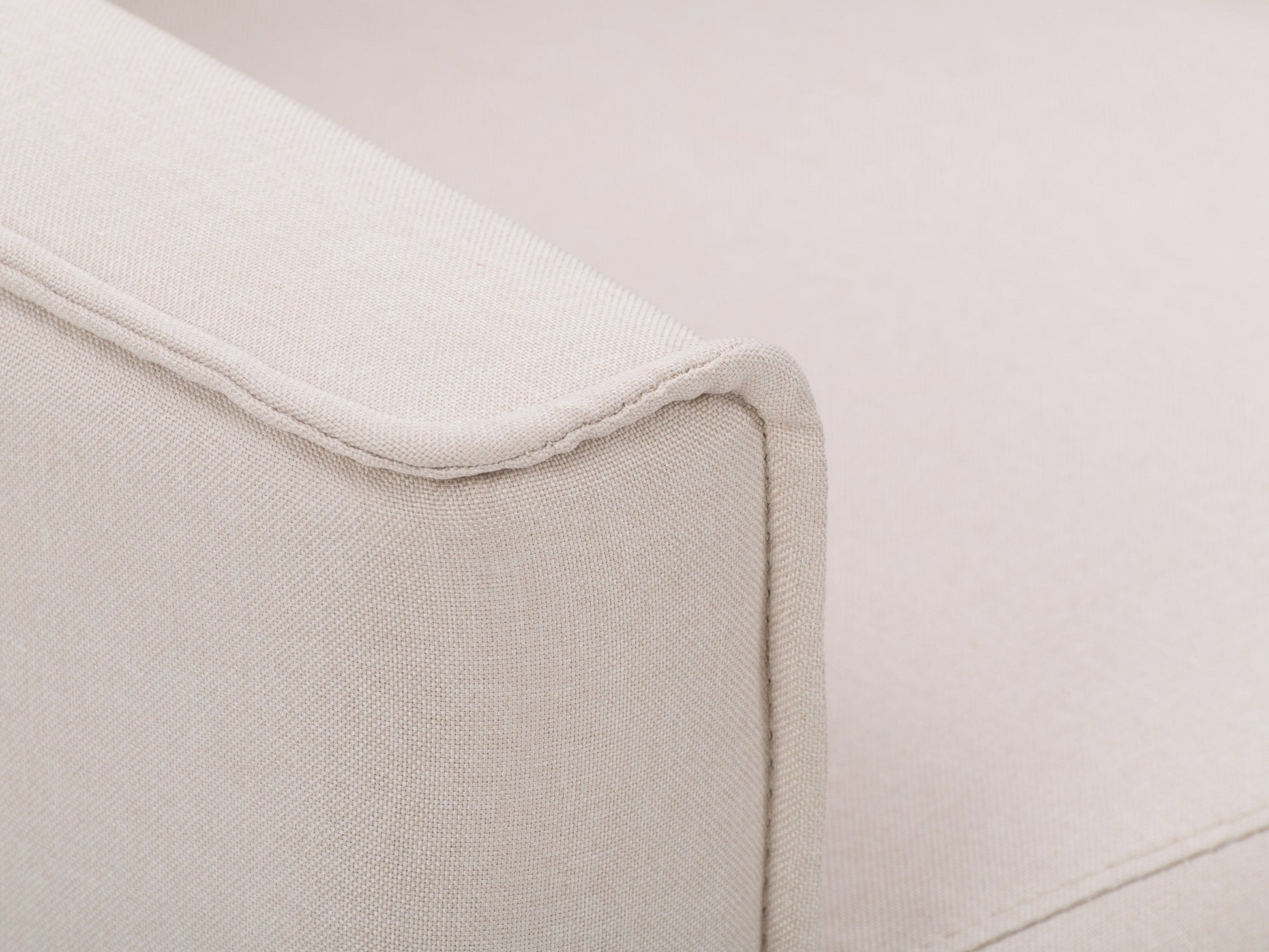 Beige mid-century recliner with wooden legs, tufted backrest, and soft fabric upholstery, featuring a sleek, minimalist design perfect for modern living rooms.