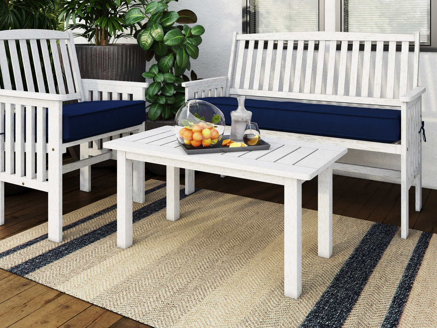 Washed white hardwood outdoor coffee table with slatted top, sturdy legs, and weather-resistant finish, perfect for patio or garden use.