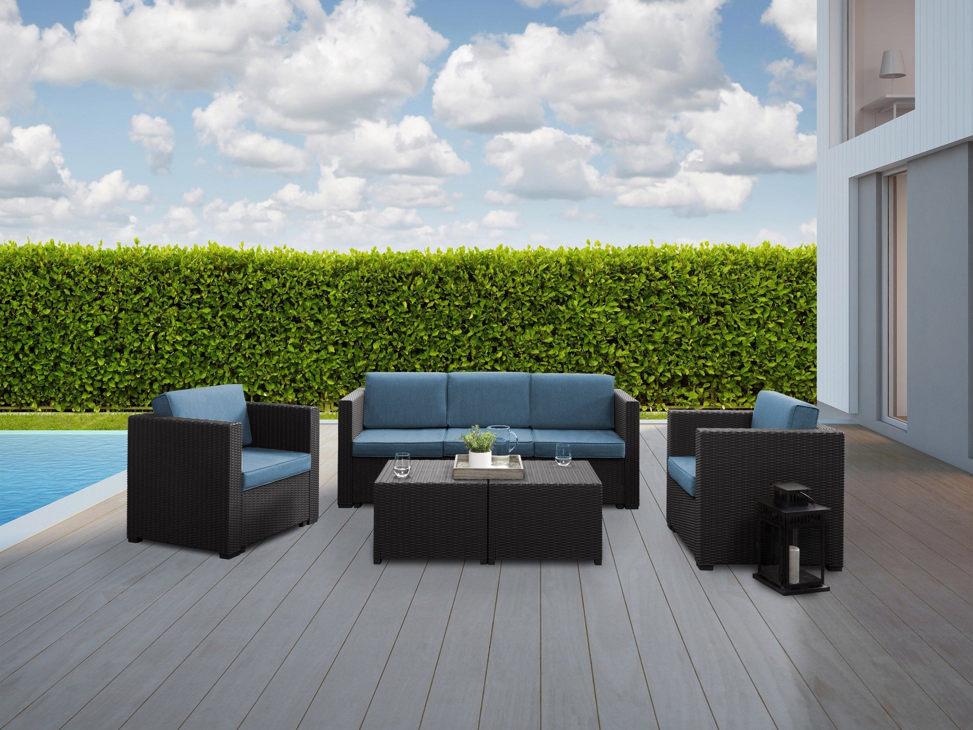5-piece patio conversation set with black metal frame, blue cushioned chairs, and a matching coffee table featuring a tempered glass top, perfect for outdoor lounging and entertaining.