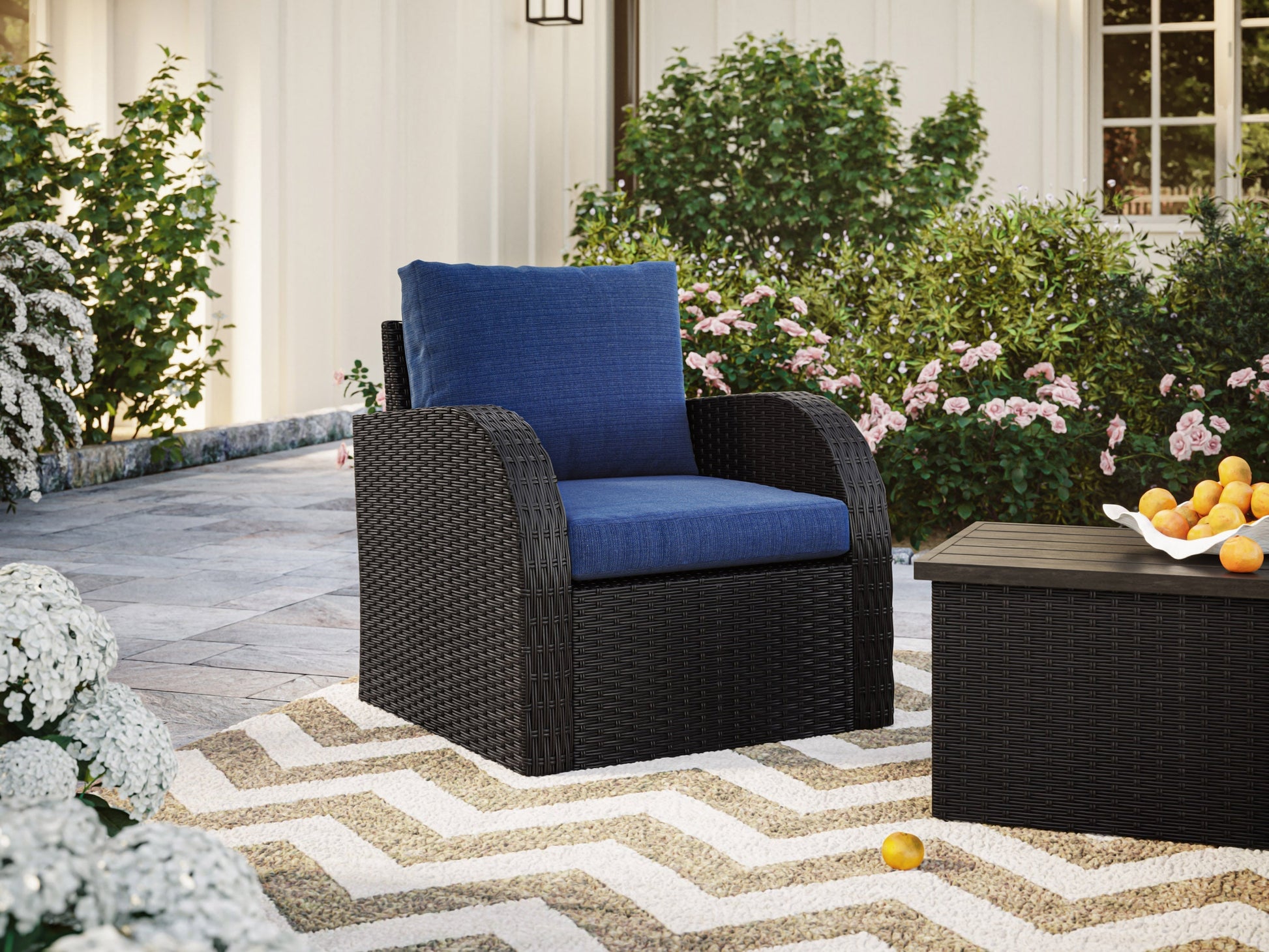 Blue outdoor wicker patio chair with cushioned seat and backrest, featuring durable woven rattan material and weather-resistant frame, perfect for garden or balcony seating.