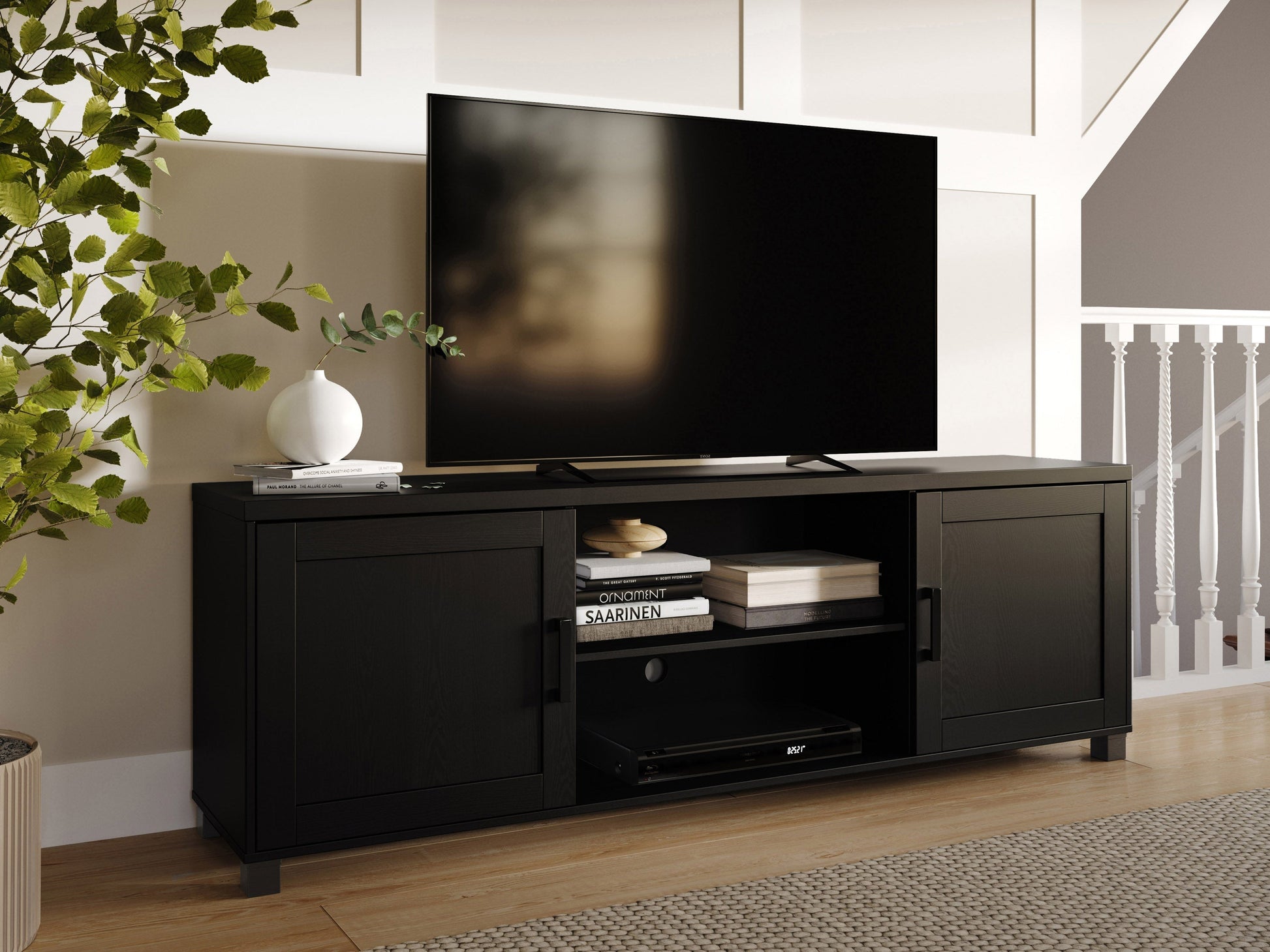 Black TV stand with doors, suitable for TVs up to 85 inches. Features sleek black finish, modern design, ample storage space with cabinets and shelves, and sturdy construction. Ideal for contemporary living rooms.
