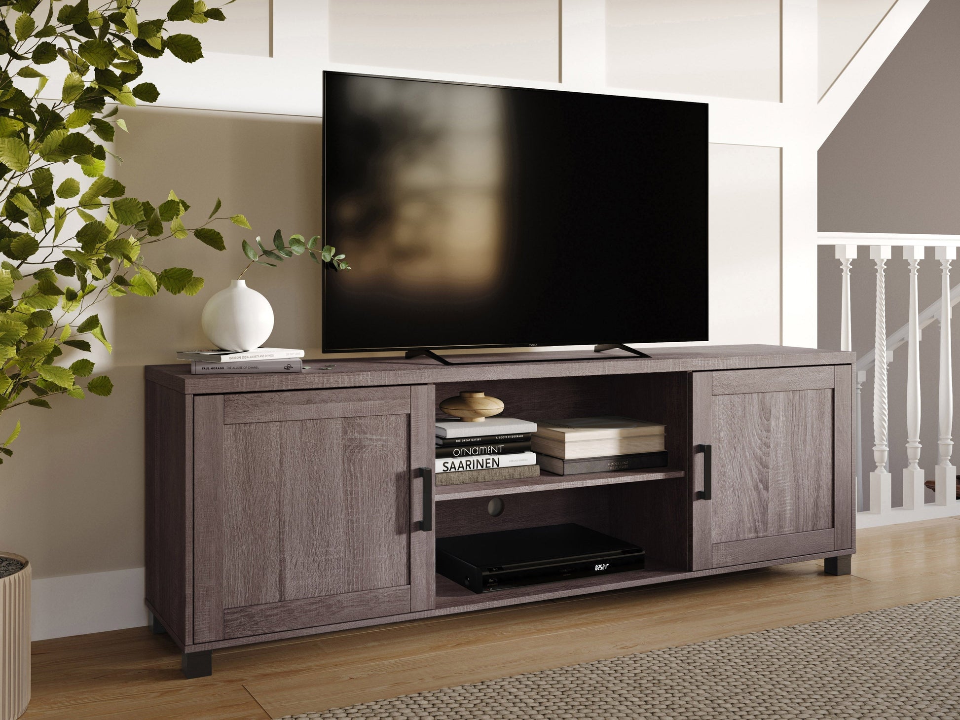 Brown wooden TV stand with doors, suitable for TVs up to 85 inches. Features a sleek design with ample storage space, including two cabinets and open shelving, perfect for living room organization.