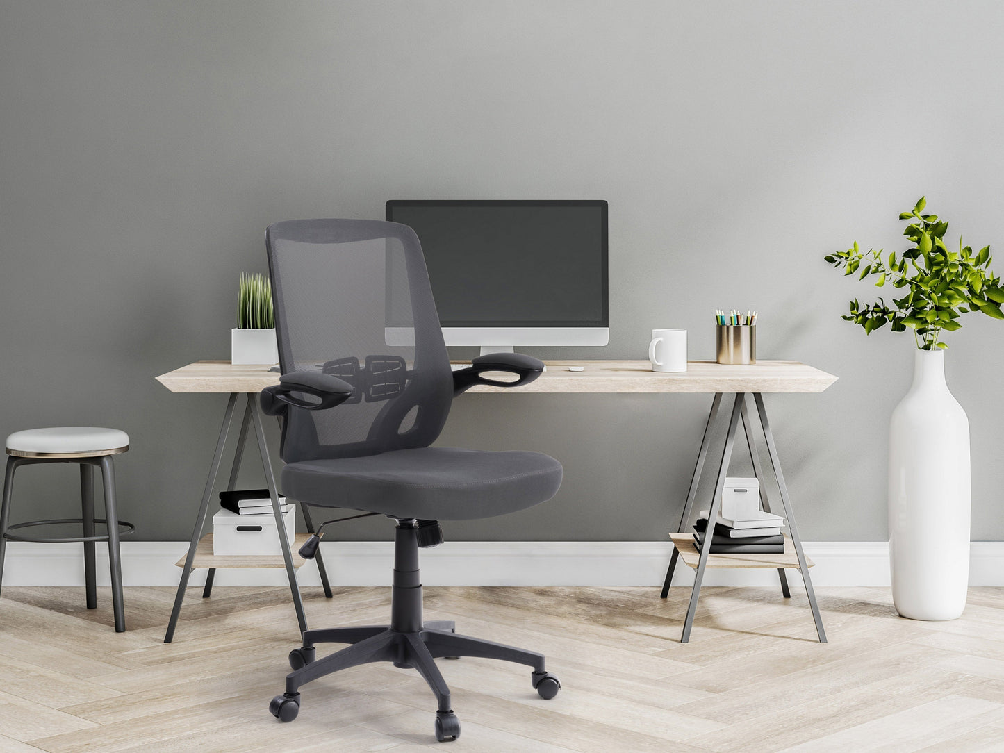 Grey mesh office chair with ergonomic design, adjustable armrests, lumbar support, and swivel base. Ideal for home or office use, providing comfort and breathability for long hours of work.