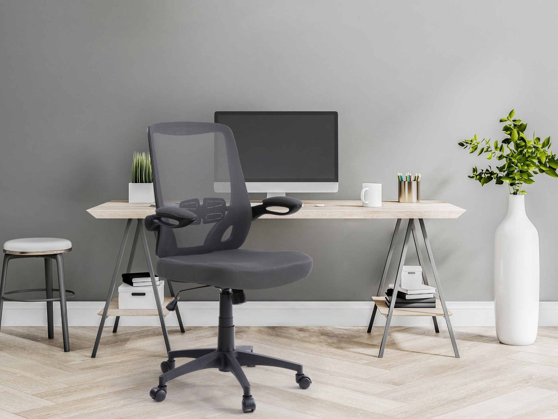 Grey mesh office chair with ergonomic design, adjustable armrests, lumbar support, and swivel base. Ideal for home or office use, providing comfort and breathability for long hours of work.