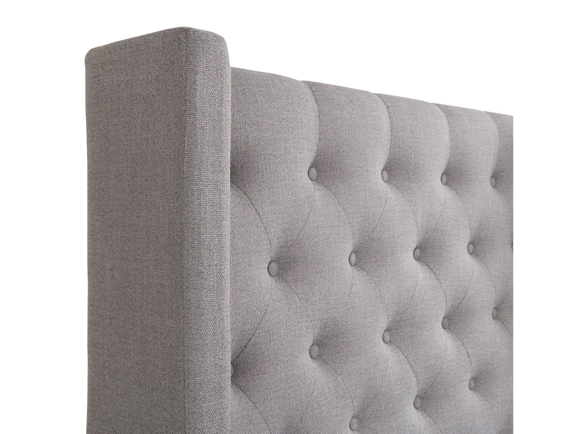 Tufted twin bed with beige upholstered headboard, wooden frame, and button-tufted details, perfect for single sleepers.