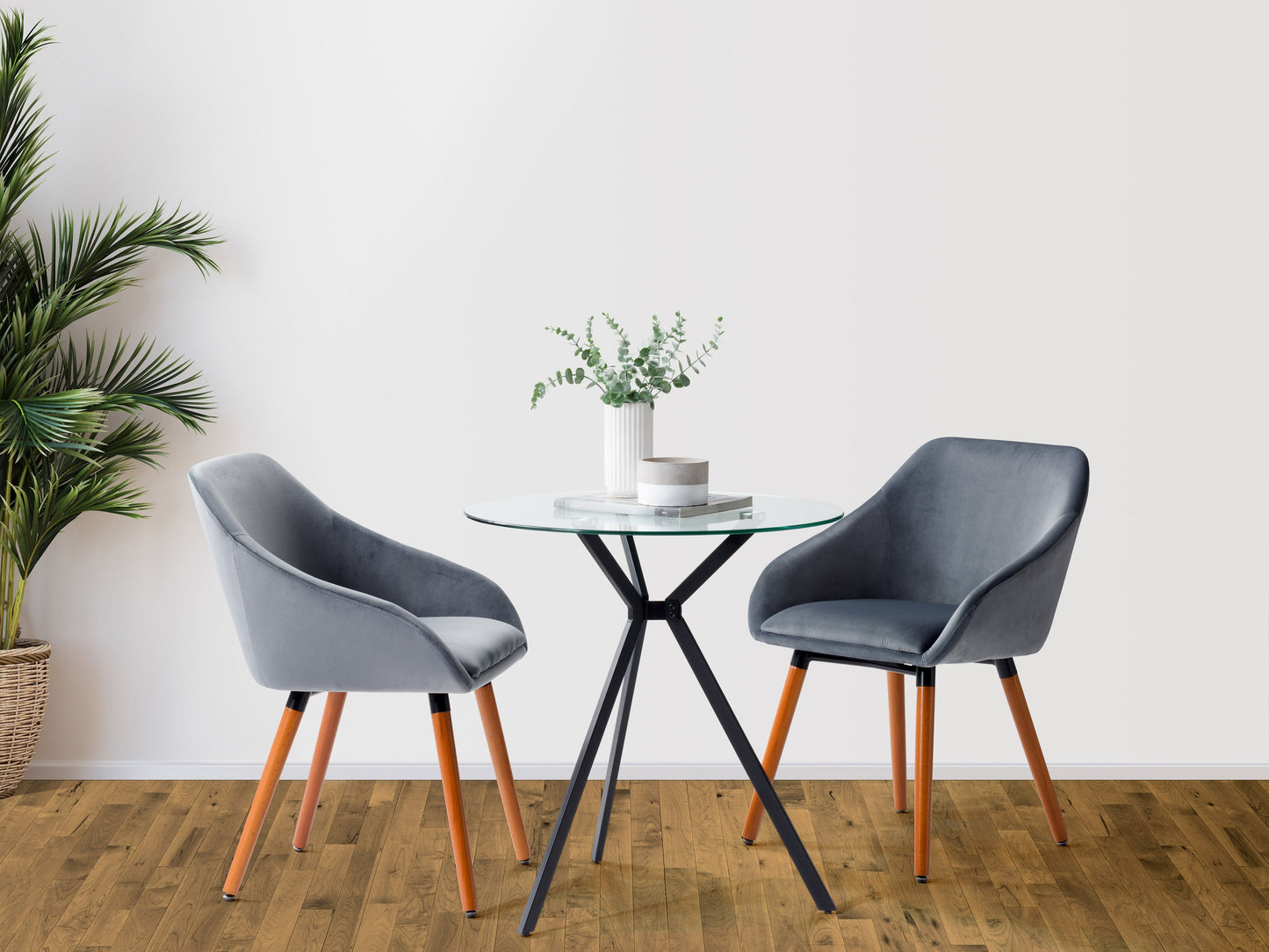 Modern glass bistro dining table with sleek black metal legs, round clear glass top, and minimalist design, perfect for contemporary kitchens or dining areas.