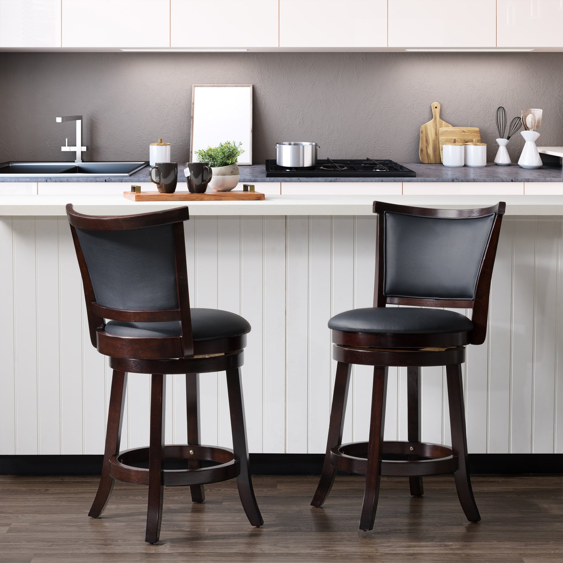 Set of 2 counter height bar stools with cushioned seats, featuring a sleek black metal frame and dark brown faux leather upholstery, perfect for modern kitchens and home bars.