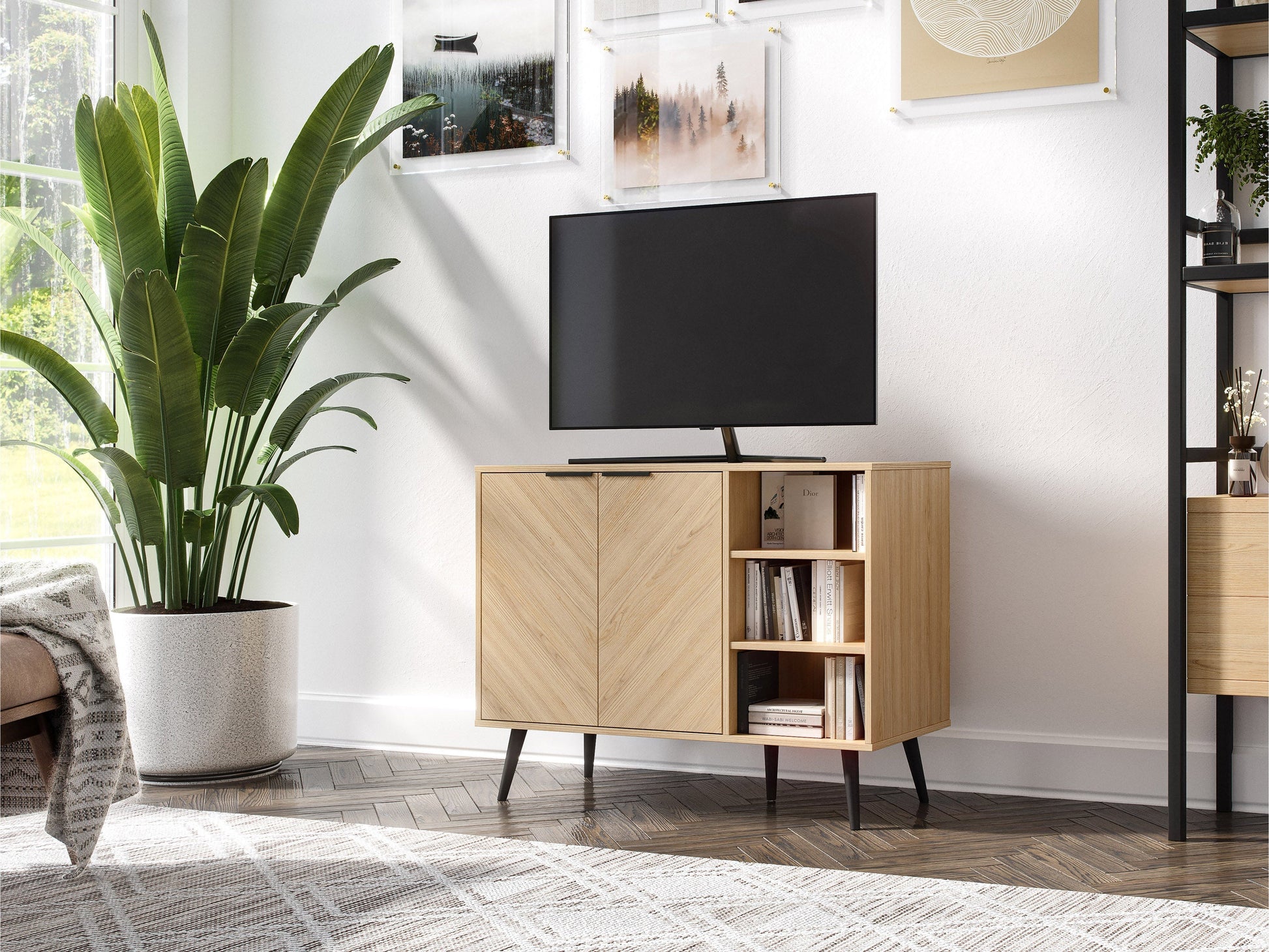 Modern sideboard buffet in light wood finish with black metal legs, featuring four cabinet doors with sleek handles and a spacious top surface for decor or storage.