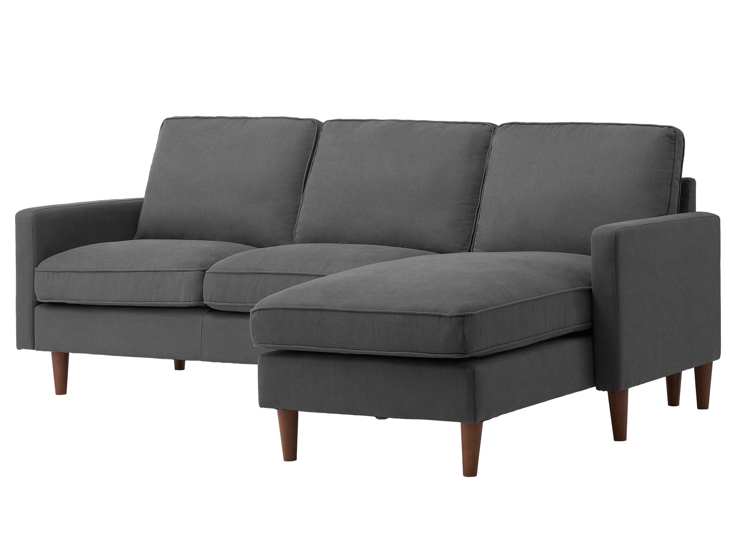 Reversible sectional sofa in light gray fabric with tufted cushions, chaise lounge, and wooden legs. Ideal for modern living rooms, offering comfort and flexibility in seating arrangements.