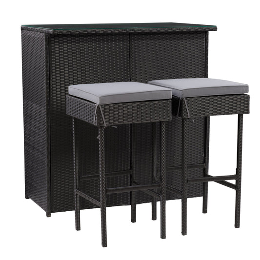 Three-piece patio bar set featuring a high table and two bar stools with beige cushions, crafted from durable, weather-resistant dark brown wicker, perfect for outdoor entertaining and relaxation.