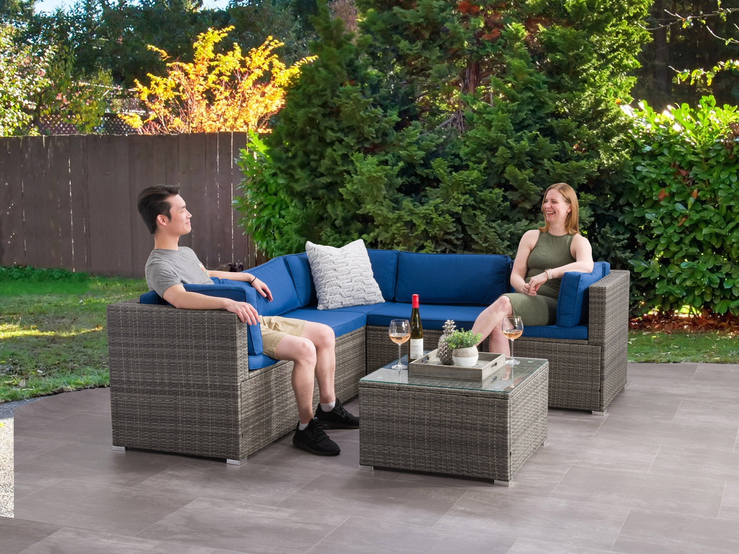 Grey wicker patio sectional set with beige cushions, featuring a modern design, weather-resistant materials, and a six-piece configuration perfect for outdoor lounging and entertaining.