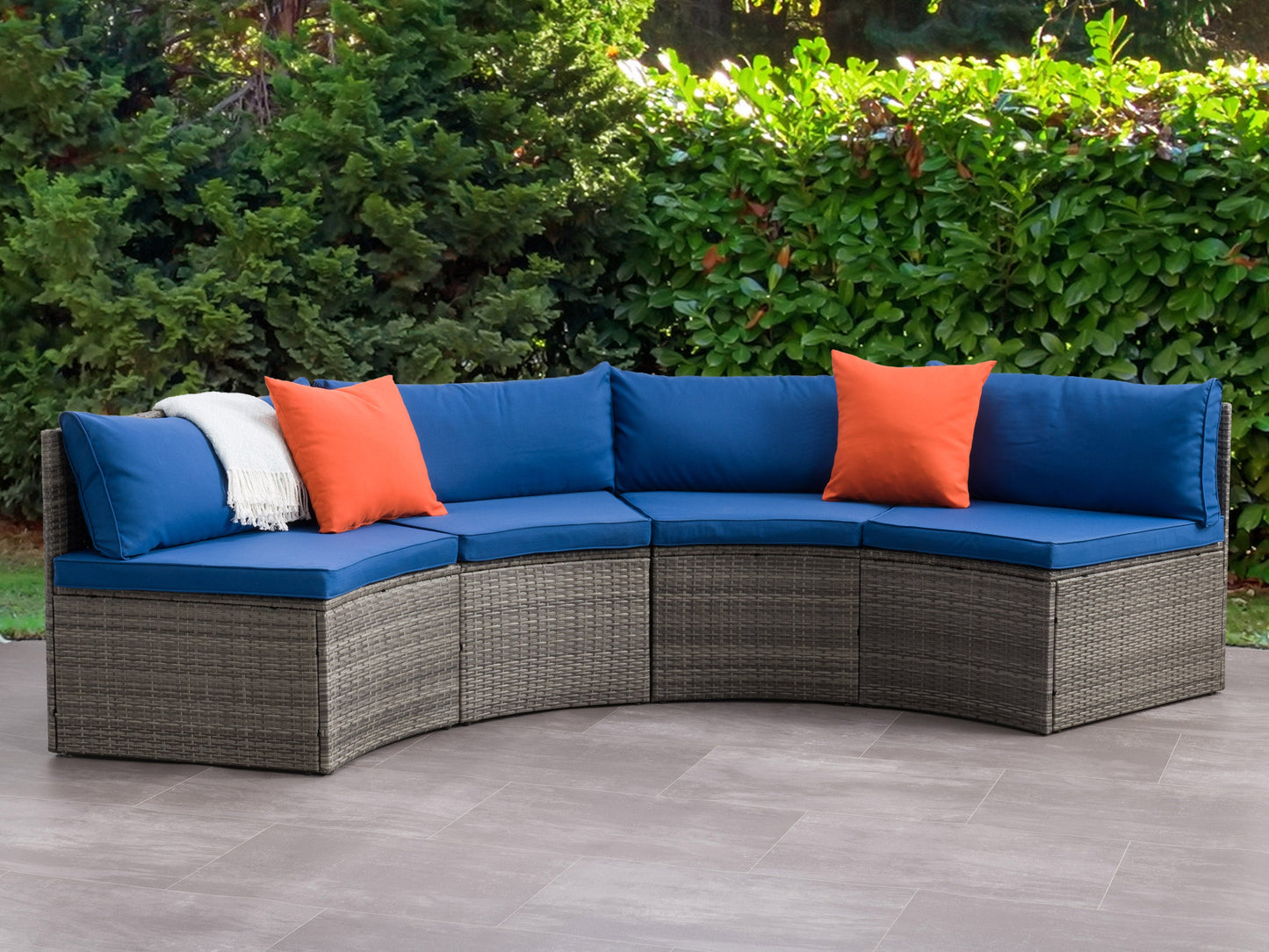 Curved outdoor sofa set with beige cushions and dark wicker frame, featuring a two-piece sectional design perfect for patio lounging.