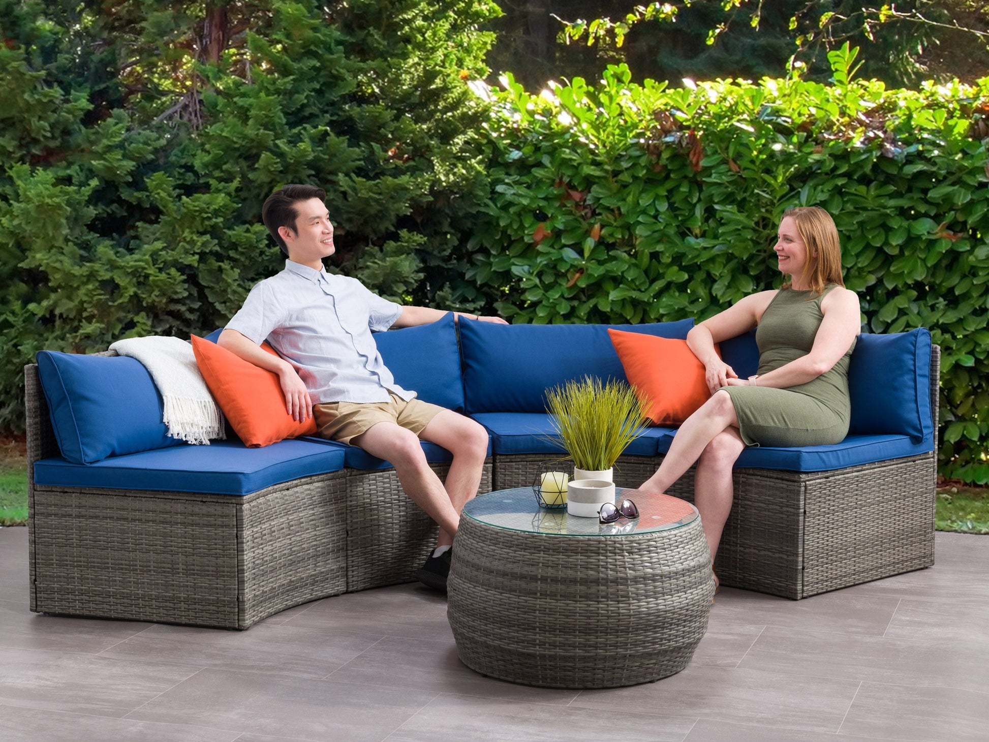 Curved outdoor patio sectional set in gray wicker with beige cushions, featuring a 3-piece design, modern curved silhouette, and durable weather-resistant materials for stylish outdoor lounging.