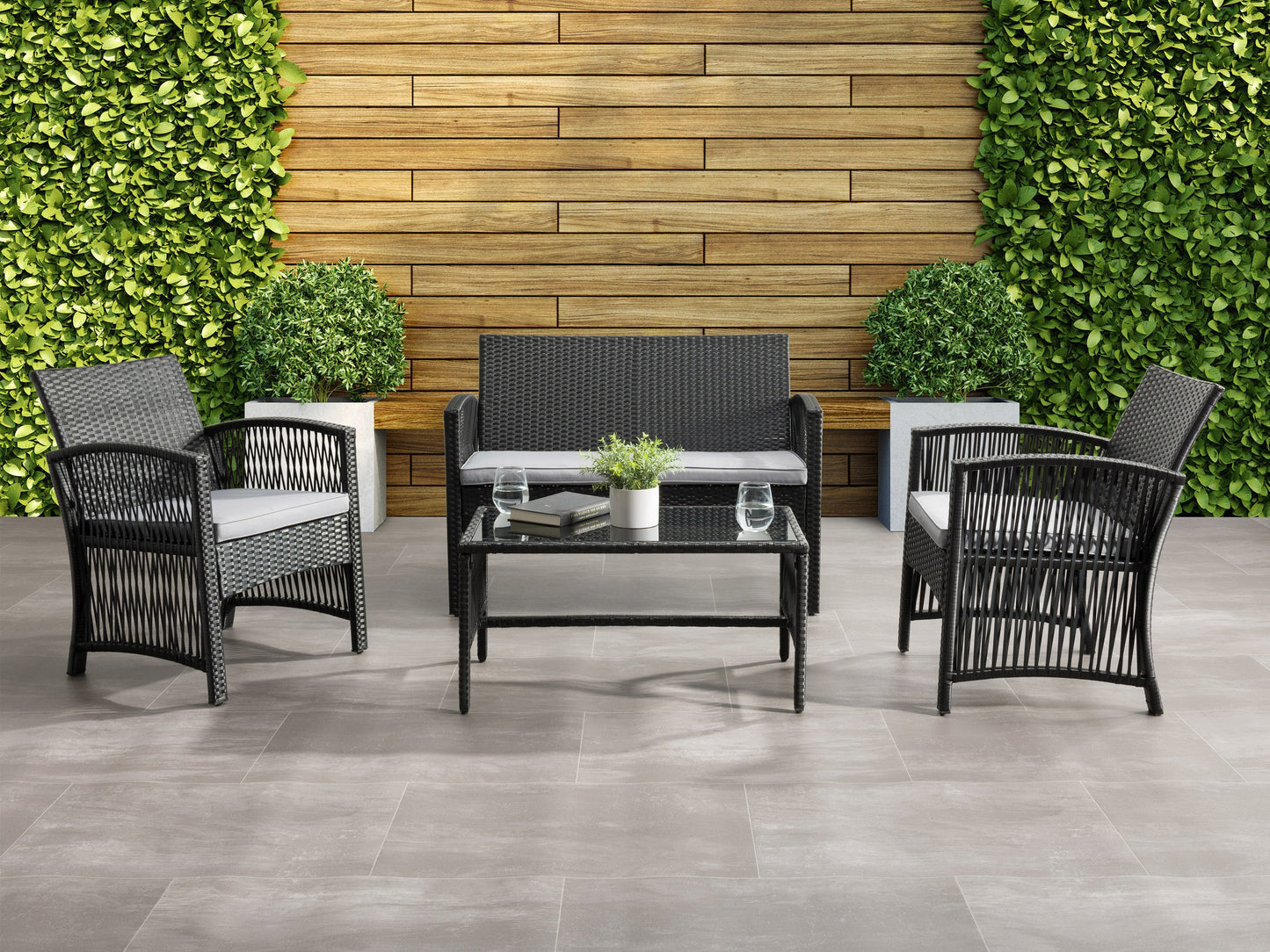 4-piece patio conversation set with gray wicker, beige cushions, and a glass-top coffee table. Includes a loveseat, two armchairs, and a table, perfect for outdoor lounging and entertaining.