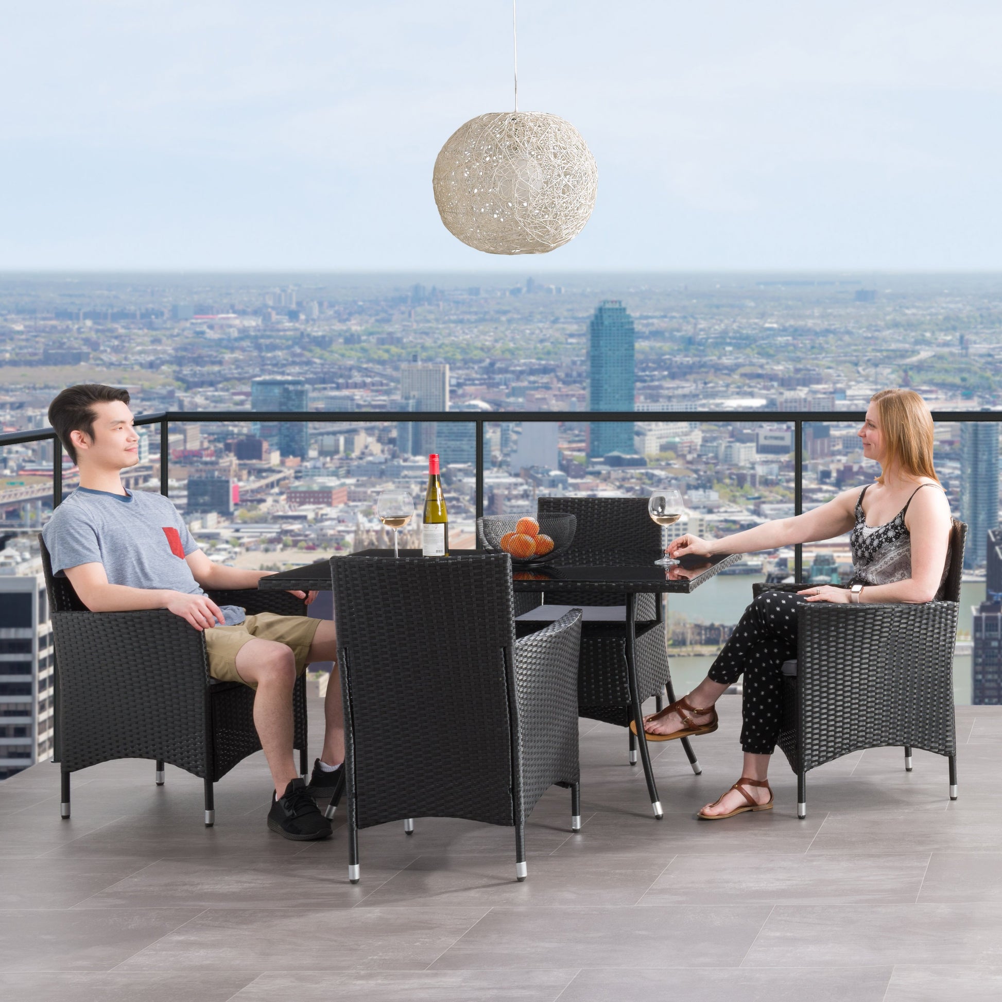 Modern 5-piece patio dining set with a rectangular glass table and four cushioned chairs in beige and brown wicker, featuring weather-resistant materials and a sleek design perfect for outdoor spaces.