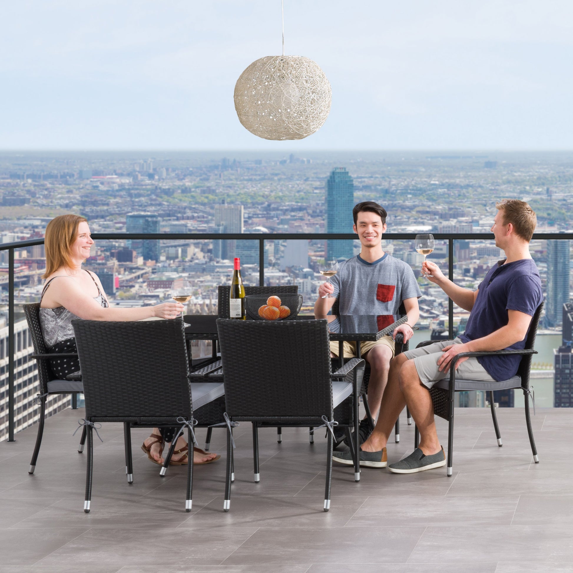 Gray wicker patio dining set with six cushioned chairs, rectangular glass-top table, and weather-resistant materials, perfect for outdoor dining and entertaining.