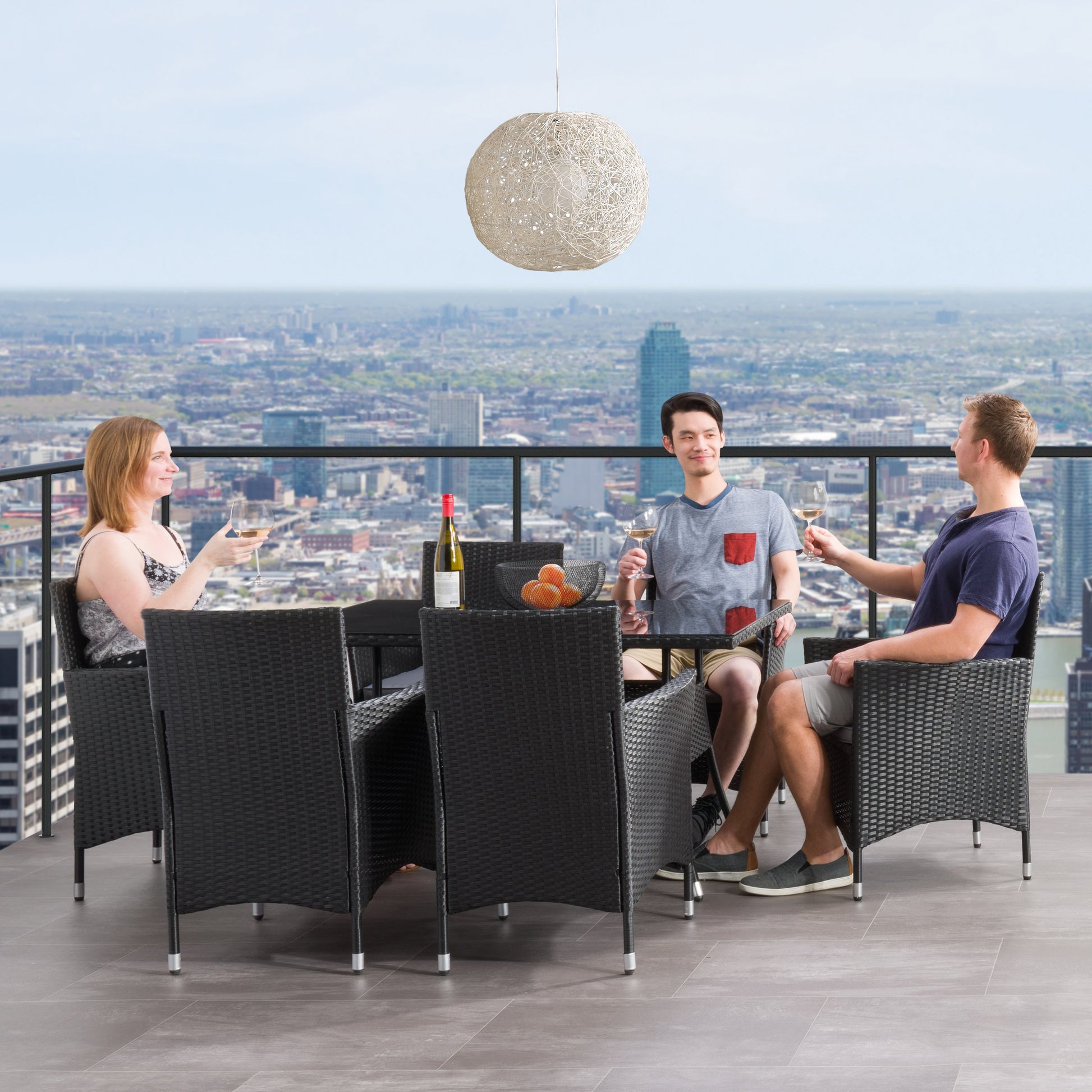 Gray wicker patio dining set with six cushioned chairs, rectangular glass-top table, and weather-resistant materials, perfect for outdoor dining and entertaining.