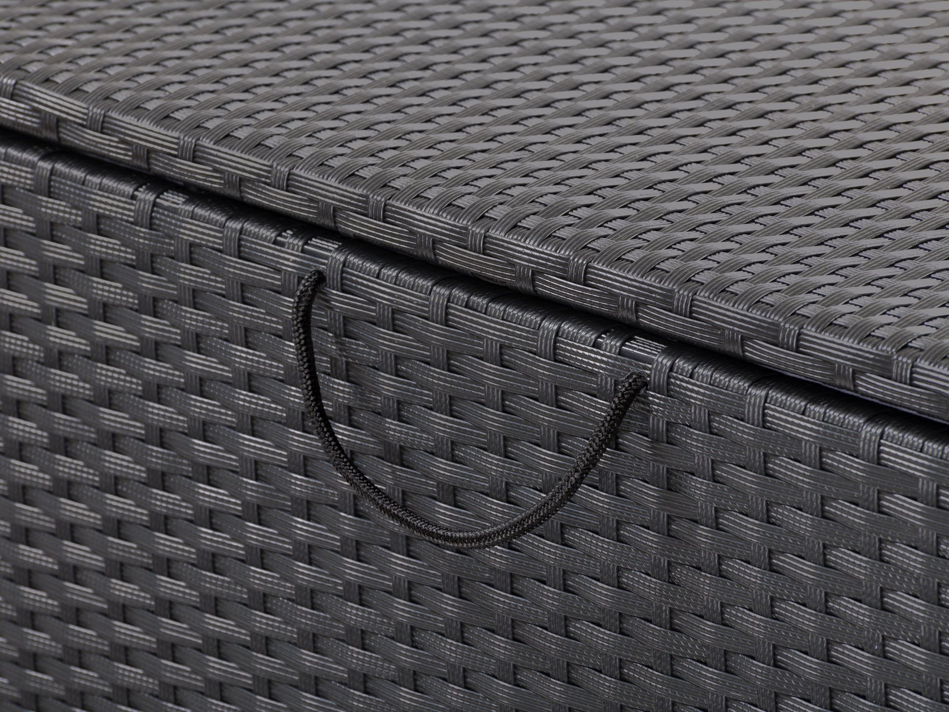 Gray wicker patio storage box with a flat lid, featuring a weather-resistant design and ample storage space, ideal for outdoor cushions and gardening tools.